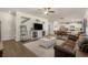 Bright and spacious living room features wood floors, a TV, and a view of the kitchen and dining area at 55 Porch Ln., Pawleys Island, SC 29585