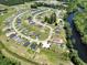 Aerial view of the neighborhood showing a scenic river and a community with well-maintained landscaping at 586 Honeyhill Loop, Conway, SC 29526