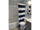 Clean bathroom with a shower and tub combo, nautical-themed shower curtain, and modern sink at 6000 N Ocean Blvd. # 122, North Myrtle Beach, SC 29582