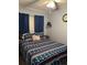 Nautical-themed bedroom offers a cozy bed with anchor patterned linens, a ceiling fan, and natural light at 6000 N Ocean Blvd. # 122, North Myrtle Beach, SC 29582