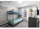 Neutral bedroom with bunk beds, dresser, and surf board decoration at 6001 - 8008 S Kings Hwy., Myrtle Beach, SC 29575