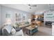 Charming living room featuring a floral sofa, light blue armchair and a glass top coffee table at 6001 - 8008 S Kings Hwy., Myrtle Beach, SC 29575