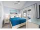 Cozy main bedroom features a bright window and a large bed with blue cover at 6001 - 8008 S Kings Hwy., Myrtle Beach, SC 29575