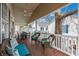 Relaxing covered porch with comfortable seating, including wicker chairs and couches with bright blue cushions and pillows at 6001 - 8008 S Kings Hwy., Myrtle Beach, SC 29575