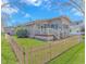 Charming home with a front porch, picket fence, and lush green lawn at 6001-Mh206 S Kings Hwy., Myrtle Beach, SC 29575