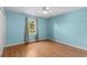 Light blue bedroom featuring wood flooring, a ceiling fan, and a window with natural light at 614 Cavandish Dr., Myrtle Beach, SC 29588