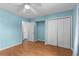 Light blue bedroom featuring wood flooring, a ceiling fan, and a closet with double doors at 614 Cavandish Dr., Myrtle Beach, SC 29588