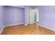 Light purple bedroom featuring wood flooring and view into connected bathroom at 614 Cavandish Dr., Myrtle Beach, SC 29588