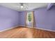 Light purple bedroom featuring wood flooring, a ceiling fan, and a window with natural light at 614 Cavandish Dr., Myrtle Beach, SC 29588