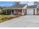 Traditional brick home with an attached garage and a well-maintained driveway at 614 Cavandish Dr., Myrtle Beach, SC 29588
