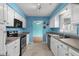 Well-equipped kitchen with stainless steel appliances, white cabinets, and views to dining area at 614 Cavandish Dr., Myrtle Beach, SC 29588