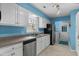 Bright kitchen equipped with stainless steel appliances, white cabinetry, and access to the laundry room at 614 Cavandish Dr., Myrtle Beach, SC 29588