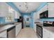 Galley kitchen featuring white cabinets, stainless steel appliances, and track lighting at 614 Cavandish Dr., Myrtle Beach, SC 29588
