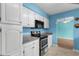 Updated kitchen featuring stainless steel oven and microwave, white cabinetry, and views to dining area at 614 Cavandish Dr., Myrtle Beach, SC 29588