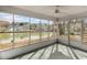 Enclosed sunroom with screened windows and a view of the lake and neighboring homes at 614 Cavandish Dr., Myrtle Beach, SC 29588