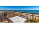 Oceanfront view from balcony with table and chairs, and metal railings at 6900 N Ocean Blvd. # 513, Myrtle Beach, SC 29572