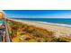 Oceanfront resort view with palm trees, beach, and bright sunshine at 6900 N Ocean Blvd. # 513, Myrtle Beach, SC 29572