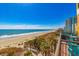 Beachfront view from balcony with palm trees, dunes, and the ocean at 6900 N Ocean Blvd. # 513, Myrtle Beach, SC 29572