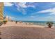 Expansive ocean view from a brick paved terrace with lounge chairs and potted palm trees at 6900 N Ocean Blvd. # 513, Myrtle Beach, SC 29572