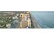 Stunning aerial view of beachfront condos along the beautiful coastline and mature trees at 7100 N Ocean Blvd. # 221, Myrtle Beach, SC 29572