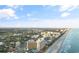 Scenic aerial view showcasing beachfront condos and a pristine coastline at 7100 N Ocean Blvd. # 221, Myrtle Beach, SC 29572