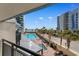 Scenic balcony view overlooking a pool, palm trees, and the ocean at 7100 N Ocean Blvd. # 221, Myrtle Beach, SC 29572