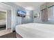 Bedroom featuring a comfortable bed, relaxing decor and a flat screen television with a peaceful beach scene at 7100 N Ocean Blvd. # 221, Myrtle Beach, SC 29572
