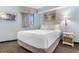 Relaxing bedroom with a comfortable bed, ambient lighting, and a scenic view from the large window at 7100 N Ocean Blvd. # 221, Myrtle Beach, SC 29572