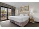 Relaxing bedroom with a comfortable bed, ambient lighting, and a private balcony with scenic views at 7100 N Ocean Blvd. # 221, Myrtle Beach, SC 29572