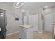 Kitchen with a center island, a clock on the wall, and access to multiple rooms at 712 Painted Bunting Dr. # B, Murrells Inlet, SC 29576