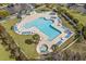 Aerial view of a resort-style pool area with ample lounge chairs, palm trees, and well-maintained landscaping at 712 Painted Bunting Dr. # B, Murrells Inlet, SC 29576