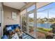 Cozy sunroom with comfortable seating and picturesque views of the lake with fountain at 712 Painted Bunting Dr. # B, Murrells Inlet, SC 29576