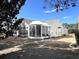 Large backyard with a sunroom addition, patio, and well-maintained lawn at 7471 Balmore Dr. Sw, Sunset Beach, NC 28468