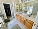 Bathroom features a double sink vanity with wood cabinets and a walk in shower at 7471 Balmore Dr. Sw, Sunset Beach, NC 28468