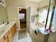 Bathroom with a soaking tub under a window, separate glass enclosed shower, and a double vanity at 7471 Balmore Dr. Sw, Sunset Beach, NC 28468