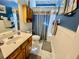 Bathroom with a vanity, toilet, and shower with blue accents at 7471 Balmore Dr. Sw, Sunset Beach, NC 28468