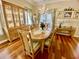 Charming dining room with hardwood floors, elegant chandelier, and a large window at 7471 Balmore Dr. Sw, Sunset Beach, NC 28468