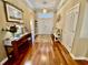 Inviting foyer with gleaming hardwood floors, a charming console table, and ample natural light at 7471 Balmore Dr. Sw, Sunset Beach, NC 28468