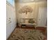 Foyer with decorative tree art, rug, and white bench at 7471 Balmore Dr. Sw, Sunset Beach, NC 28468