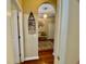 Inviting hallway features wood floors and an archway leading to the foyer at 7471 Balmore Dr. Sw, Sunset Beach, NC 28468