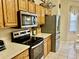 Bright kitchen featuring stainless steel appliances, light-colored countertops, and wood cabinets at 7471 Balmore Dr. Sw, Sunset Beach, NC 28468