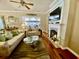 Elegant living room with a fireplace, ceiling fan and access to the screened porch at 7471 Balmore Dr. Sw, Sunset Beach, NC 28468
