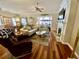 Spacious living room with hardwood floors, a cozy fireplace, and an abundance of natural light at 7471 Balmore Dr. Sw, Sunset Beach, NC 28468