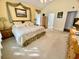 Relaxing main bedroom with carpet, high ceilings, and ensuite bathroom at 7471 Balmore Dr. Sw, Sunset Beach, NC 28468