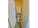 Powder room featuring a toilet and a sink, along with a door leading to the hallway at 7471 Balmore Dr. Sw, Sunset Beach, NC 28468