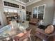 Cozy sunroom features a glass table, seating, and plenty of natural light at 7471 Balmore Dr. Sw, Sunset Beach, NC 28468