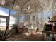 Bright sunroom boasts lots of windows and cozy seating area at 7471 Balmore Dr. Sw, Sunset Beach, NC 28468