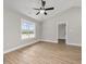 This bedroom features wood-look flooring, a ceiling fan, and a view outside the window at 813 Highway 67, Loris, SC 29569