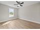An empty room with an installed ceiling fan, window, and new vinyl flooring at 813 Highway 67, Loris, SC 29569