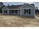 Charming one-story home with gray siding, black shutters, and a dark roof at 813 Highway 67, Loris, SC 29569